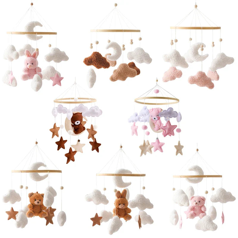 Wooden crib mobile set with soft felt animals, stars, clouds, and moons in neutral and pink tones for newborn sensory development.