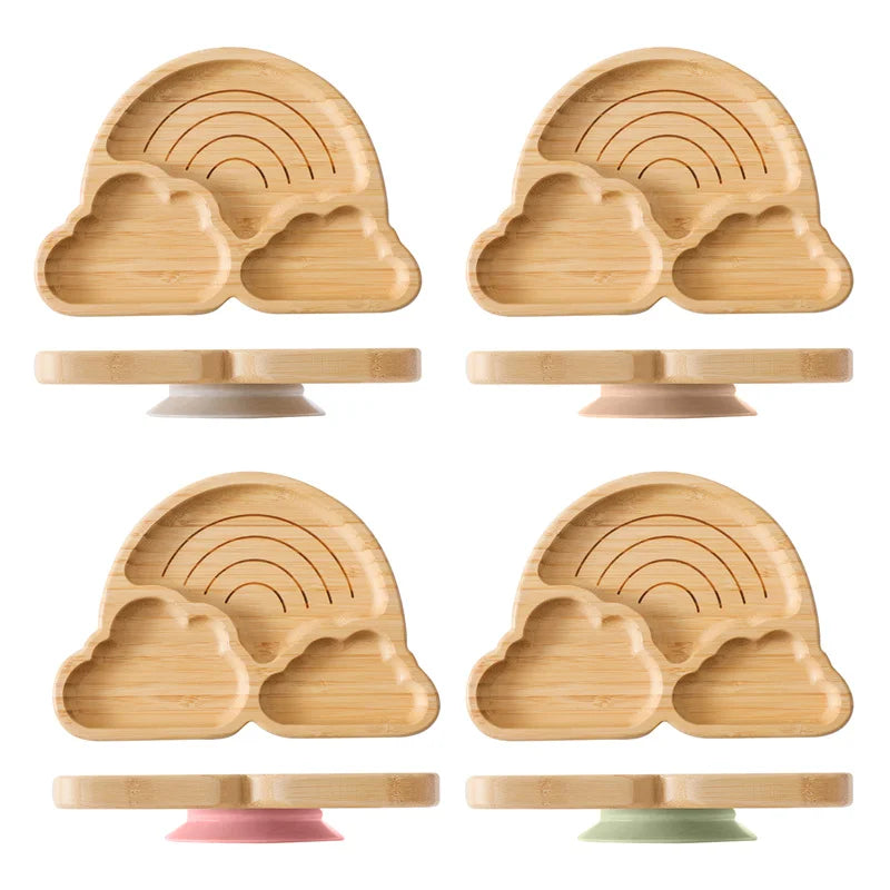 Set of eco-friendly baby wooden tableware with bamboo rainbow and cloud-shaped plates and silicone suction bases for safe feeding