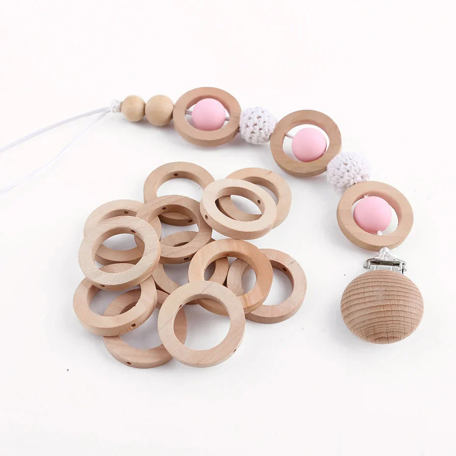 Natural wooden teething rings set with smooth round rings for DIY baby toys and safe chewing.