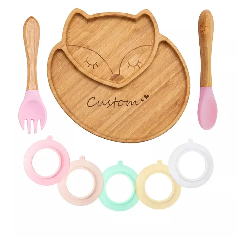 Custom baby feeding set with bamboo fox-shaped plate, pink spoon and fork, and colorful silicone suction cup rings