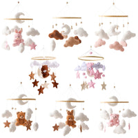 Wooden crib mobile set with soft felt animals, stars, clouds, and moons in neutral and pink tones for newborn sensory development.