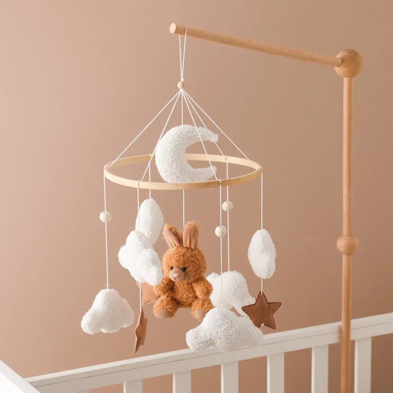 Baby rattles bed bell mobile with velvet rabbit, plush clouds, moon, and wooden star hanging above crib