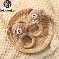 Crochet bunny baby rattle with wooden ring teether on woven tray