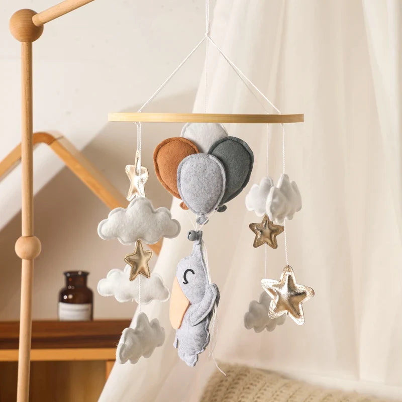 Wooden crib mobile with soft felt balloons, clouds, and star hanging toys for nursery decor and sensory development