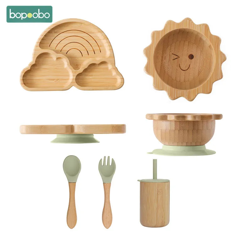 Bamboo baby suction plate set with non-slip silicone base, includes divided plate, bowl, cup, spoon, and fork for stress-free, BPA-free infant feeding.